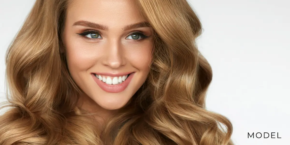 Model with Amazing Hair Standing in Front of White Background