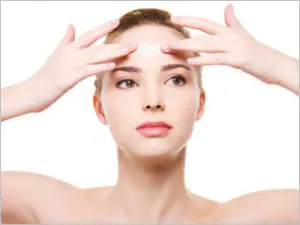 Woman touching her forehead