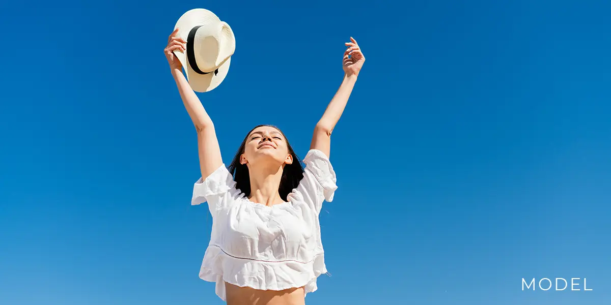 Woman Outdoors Raising Her Arms