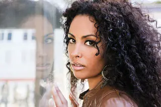 African American Model Posing Near a Reflective Shop Window