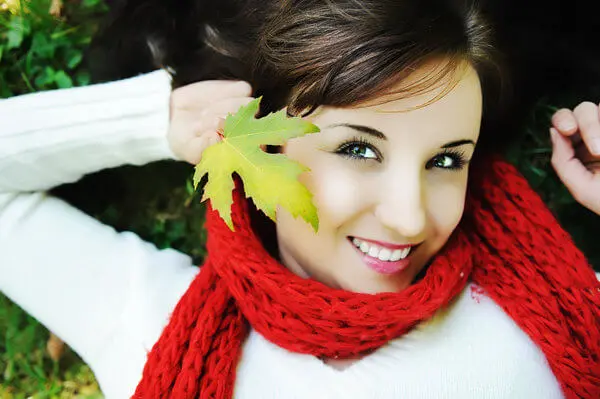 Woman Lying on the Grass Playing with a Leaf
