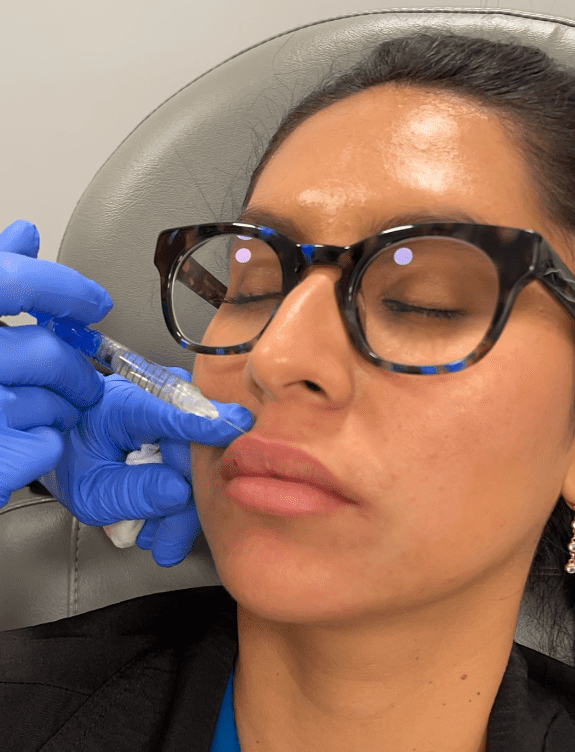 A young woman gets lip filler