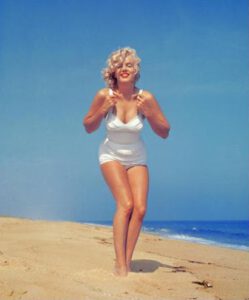 Marilyn Monroe in a white swimsuit at the beach