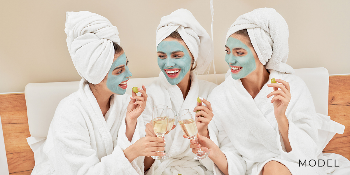 Three Women with Skincare Masks in Spa Robes