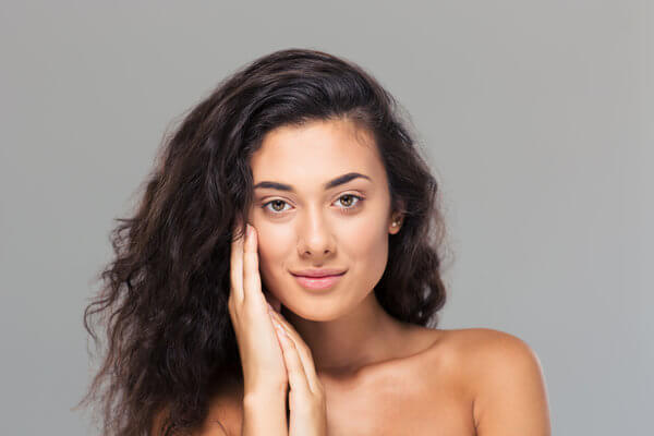 Woman Holding Her Hands Against Her Smooth Face