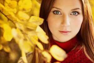 Botox Model in Red Sweater Next to Yellow Leaves